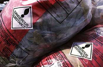 Bagged asbestos awaits disposal in a landfill