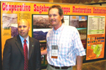 Chief Lancaster talks with one of the exhibitors at the SWCS Annual Meeting (NRCS photo -- click to enlarge)