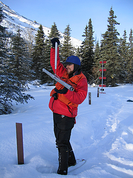 NPS scientist Chad Hults measuring snow