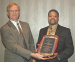 from left) Donnie Buckland, Senior VP of QU, presents Mike Andrews with NBCI Award