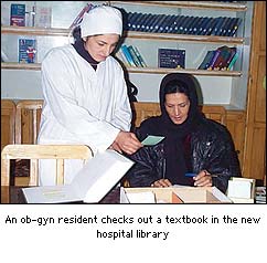 OB/GYN resident checks out a textbook in the new hospital library