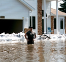 man standing in flood waters