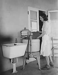 Woman removing cover from her electric washing machine