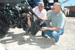 farmer Doug Seltz and NRCS District Conservationist Denis Schulte examine the injection knives and coulters of a strip-till implement. Seltz recently bought a strip-till system for his Webster County farm. Seltz expects the new conservation tillage system to improve soil quality on his farm and pay for itself in about two years