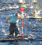 Smith College engineering student Cora Olson surveys the Town River channel near West Bridgewater, Massachusetts