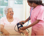 Photo of an elderly patient receiving a blood pressure test