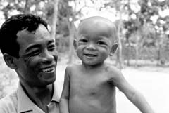 Photo of a man and his son smiling in Thailand.