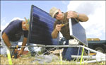 Jon Werner, right, director of the Water and Climate Center in Portland, Ore., right, and Stan Fox assemble the Soil Climate Analysis Network weather monitoring system Tuesday afternoon at the North Alabama Horticulture Research Center (photo by Amanda Shavers courtesy of The Cullman Times)