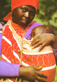 A photo of a woman holding a baby strapped to her chest. Source: Judith McCord.