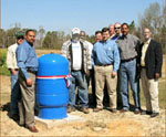 (from left) urban conservationist Bill McGraw, NRCS area conservationist Wesley Kerr, landowner Donnie Travis, NRCS district conservationists Mike McNair and Paul Caves, Chief Knight, NRCS soil conservation technician Danny Box, Mississippi Soil and Water Conservation Commission member Don Underwood, Mississippi NRCS State Conservationist Homer Wilkes, and NRCS Special Assistant to the Chief Sam Thornton