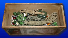 Cords and sockets packed inside of a wooden crate.