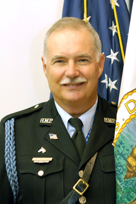 Officer Donovan in uniform; American flag in background