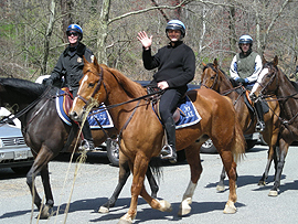 U.S. Park Police Officer and training-class participants riding on horseback.
