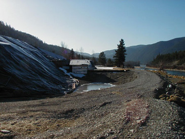 Contaminated soil is covered with a heavy tarp