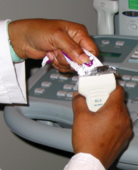 Diane Johnson puts a water soluble gel on a transducer that directs high-frequency sound waves to the artery or vein being examined.