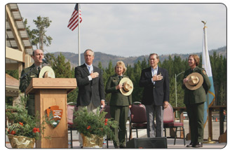 Michael Breis sings the Star-Spangled Banner at Yellowstone 90th Anniversary Celebration. Standing from left to right are Secretary Kempthorne, Director Mainella, Senator Thomas, and Superintendent Lewis.