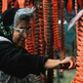 Native woman drying salmon on racks