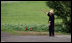 A resident of Makkari waves as the G-8 Spouses pass by en route Tuesday, July 8, 2008, to Hokkaido Marche, a famer's market, on Japan's northern island of Hokkaido, site of the 2008 G-8 Summit.