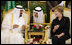 With the help of an interpreter, Mrs. Laura Bush shares a greeting over coffee with King Abdullah bin Abdulaziz during the arrival ceremonies Friday, May 16, 2008, for she and President George W. Bush at the Riyadh-King Khaled International Airport in Riyadh.