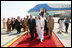 President George W. Bush and King Abdullah bin Abdulaziz walk with an entourage of greeters Friday, May 16, 2008, after the President's arrival at Riyadh-King Khaled International Airport in Riyadh.