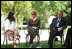 Mrs. Laura Bush and President George W. Bush listen to a young participant during a roundtable discussion Friday, May 16, 2008, in the garden of the Bible Lands Museum Jerusalem.