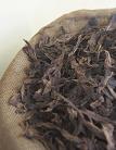 Close-up of dried tobacco leaves in a sack