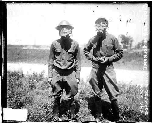 Enlarged image of Captain Oscar Solbert, wearing a gas mask and holding a hand grenade.