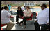 Mrs. Laura Bush listens to Dr. Mohamed Salem, Head of the South Sinai Protectorates, Egyptian Environmental Affairs Agency, as they prepare to depart for a coral reefs and ocean conservation tour Saturday, May 17, 2008, in Sharm El Sheikh, Egypt. Joining them are Ms. Hilda Arellano, USAID Cairo Mission Director, and Mr. Amir Ali, Hurghada Environmental Protection and Conservation Association.