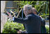 President George W. Bush waves as he walks with Afghanistan President Hamid Karzai Saturday, May 17, 2008, following their meeting with members of the media in Sharm el-Shiek, Egypt.