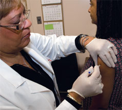 nurse immunizing a patient
