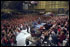 After being greeting by a loud chorus of U.S.A, U.S.A., President George W. Bush addresses an enthusiastic crowd of troops at Elmendorf Air Force Base in Alaska, Saturday, Feb. 16, 2002. White House photo by Eric Draper.