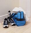 View of sports bag, water bottle, running shoes and a towel