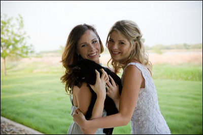 Barbara and Jenna Bush share a special moment with Willie, the Bush family cat, on Jenna's wedding day May 10, 2008. White House photo by Paul Morse.
