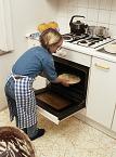 Young person entering food in oven