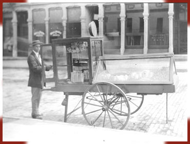 Vendor with popcorn cart