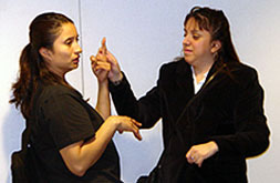 An SSP is using tacile sign language with board member Emily Vera.