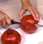 Instructional photo of preparing a pomegranate