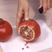 Instructional photo of preparing a pomegranate