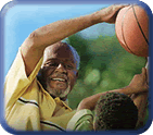 Older man and boy playing basketball