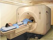 Magnetic resonance imaging (MRI) of the abdomen; drawing shows the patient on a table that slides into the MRI machine, which takes pictures of the inside of the body. The pad on the patient’s abdomen helps make the pictures clearer.