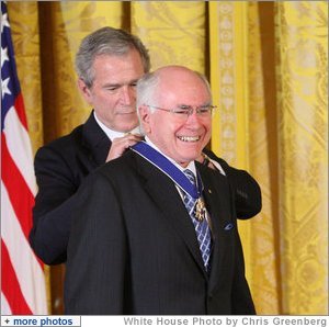 Former Prime Minister John Howard of Australia, smiles as President George W. Bush presents him with the 2009 Presidential Medal of Freedom Tuesday, Jan. 13, 2009, during ceremonies in the East Room of the White House. Established in 1963, the Medal may be presented to "any person who has made an especially meritorious contribution to the security or national interests of the United States, or world peace or cultural or other significant public or private endeavors." White House photo by Chris Greenberg