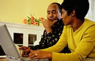 Man and woman sitting in front of a laptop