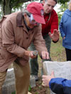 Instructor Martin Johnson explains to Margo Stringfield how to remove failed mortar. (Mary Striegel)