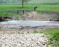 this double-wide livestock crossing on the Sweeney-Olmstead property line was constructed last year, so both herds can utilize it -- heavy rains in early may caused some rock to wash away and sediment runoff (NRCS photo by Jason Johnson – click to enlarge)