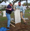 Participant Stan Rogers helps instructor Karl Munson remove a stone for resetting. (Jason Church)