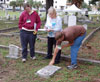 Staci Richey, Chandra Reedy and William Lamb do a conditions assessment on a damaged grave marker. (Jason Church)