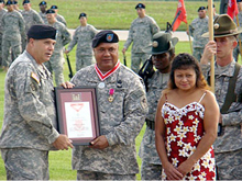 Maj. Gen. William McCoy, Commanding General US Army Maneuver Support and Ft. Leonard Wood presented one of the many awards that Command Sgt. maj. Ioakimo Falaniko and wife Maliana received during the retirement ceremony at Gammon Field, September 19, 2008. CSM Falaniko retires after 32 years of dedicated services to the US Army. CSM Falaniko is described by his commander as a master of his profession, passion of soldiers and embodied all the values and attributes of a soldiers creed.[Courtesy Photo}