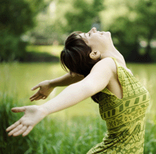 Photo of joyful young woman in meadow.