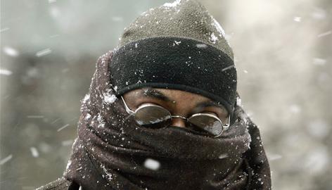 A man walks bundled against the cold and snow on Thursday morning in Trenton, N.J.