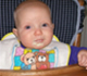 Infant Eating in a High Chair